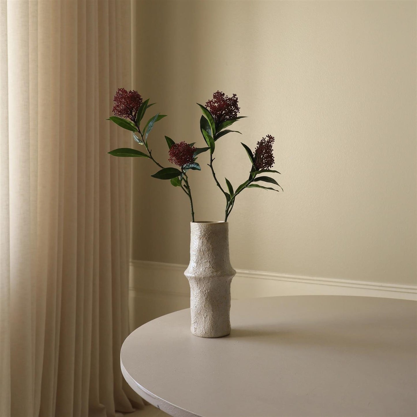 Purple skimmia berry branch